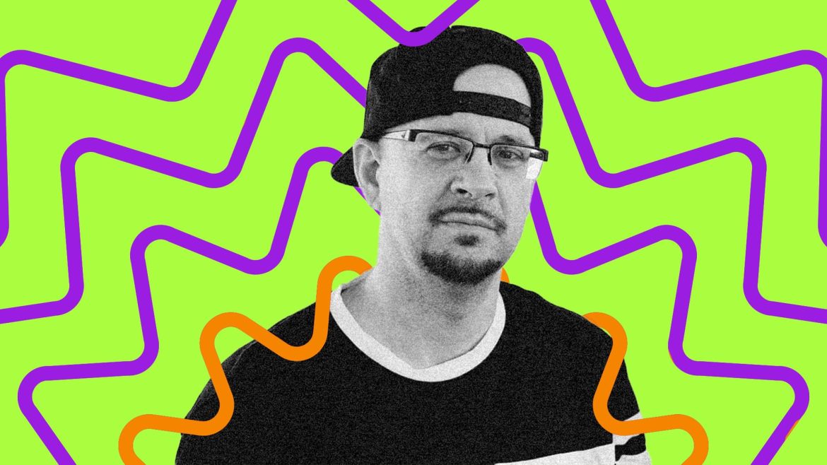 DJ Creativity looks directly at the camera with pensive expression