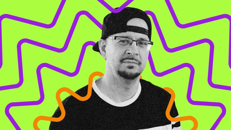 DJ Creativity looks directly at the camera with pensive expression