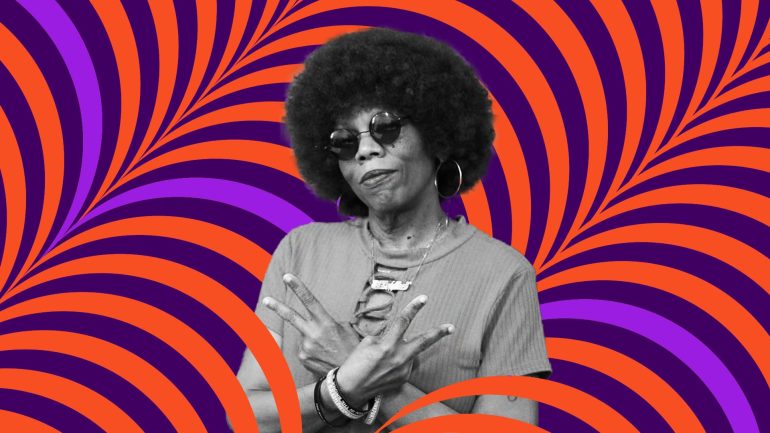 DJ Lady Love makes two peace signs with her arms crossed in front