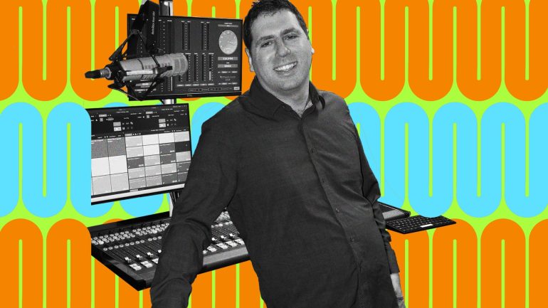 Matt leans back while smiling at the camera, recording equipment behind him