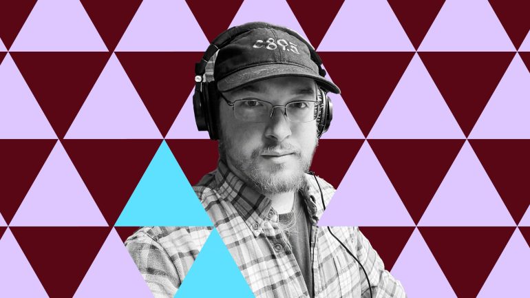 William Mayfield looks at the camera with pensive expression, wearing c89.5 baseball cap