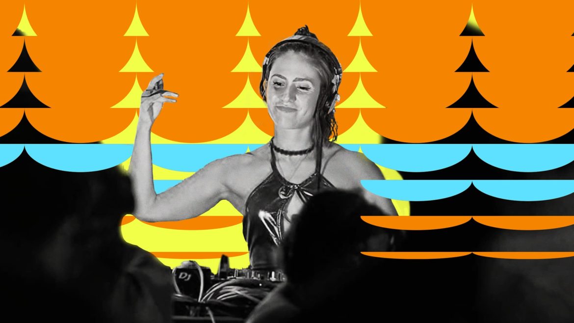 Madlon DJing while smiling and looking down at the decks