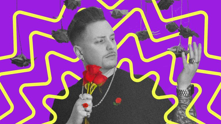 Grayson rose, mostly in black and white, holds a bouquet of red roses, with a red rose ring and a red rose print on his shirt, while holding a hand up to touch black & white roses