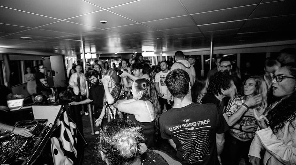 A crowded room filled with diverse people dancing