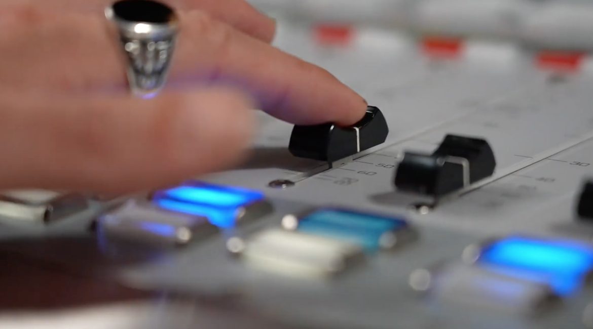 Close-up of person using mixing board